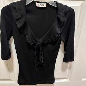 Black top. Size small. Poly/spandex. Ruffle detail collar.